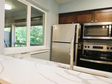 Kitchen featuring light stone counters, tasteful b
