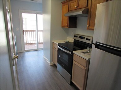 Kitchen featuring baseboards, light countertops, u