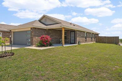 Ranch-style home featuring a garage, brick siding,