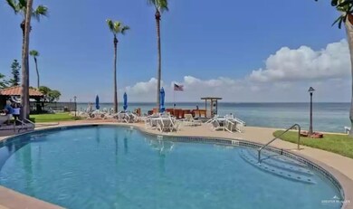 View of swimming pool with a water view and a patio