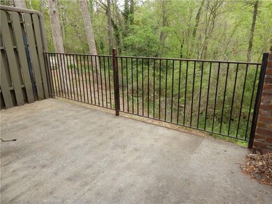 Balcony faces private wooded area with creek