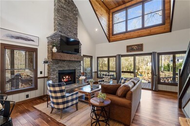 Family room with beautiful stone fireplace to vaulted ceiling