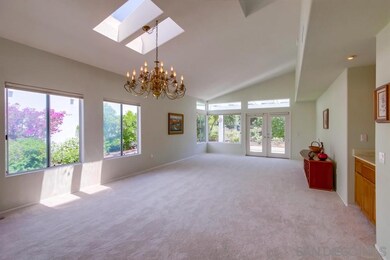 The great room with soaring ceilings and lots of l