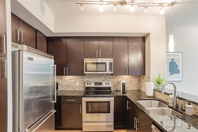 Kitchen with stainless steel appliances, a sink, 