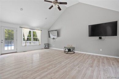 Unfurnished living room with high vaulted ceiling,