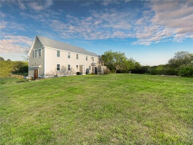 Back view of home with lovely lawn.