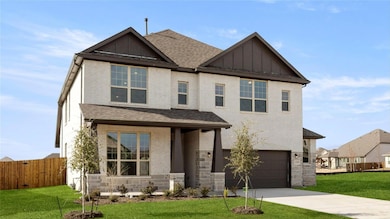View of front of house featuring board and batten siding, roof with shingles, and brick siding