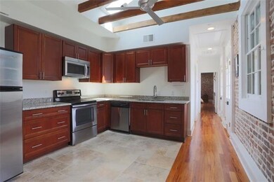 Kitchen looking towards first full bath and primar