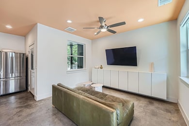 Living room featuring concrete flooring, a ceilin