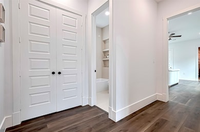 Modern hallway with rich dark wood flooring, crisp