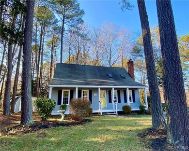 View of front of house with a front yard and cover