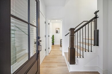 A well-designed foyer features soaring ceilings an