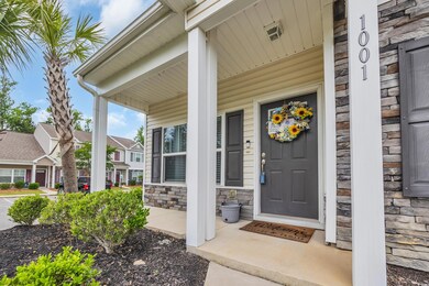 Property entrance featuring a porch and stone siding