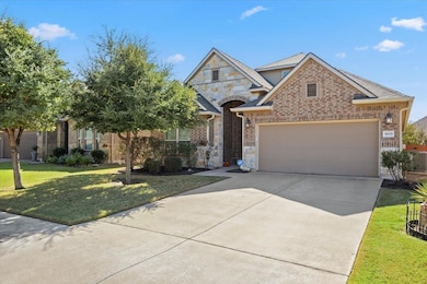 View of front of property with brick siding, driv