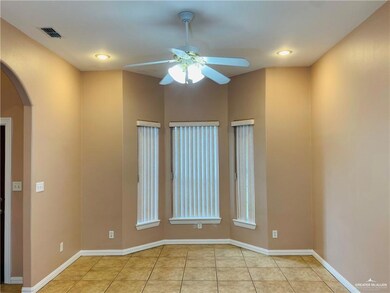 Spare room with arched walkways, ceiling fan, light tile patterned floors, and recessed lighting
