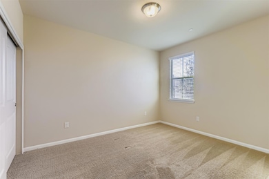 Empty room featuring light carpet and baseboards