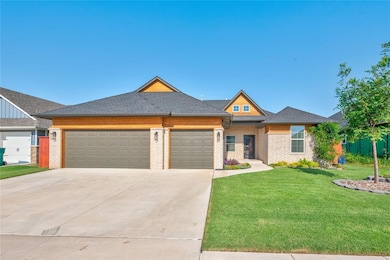 View of front of home featuring a garage, a front lawn, concrete driveway, and brick siding
