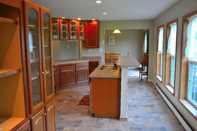 Sunny kitchen with breakfast bar,...