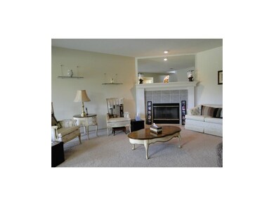 Spacious living area with wood burning fireplace.