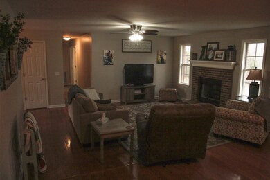 Living Room with Brick Fireplace and Wood Finish Floors