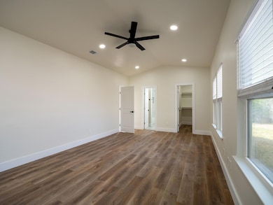 Unfurnished bedroom with a walk in closet, recess