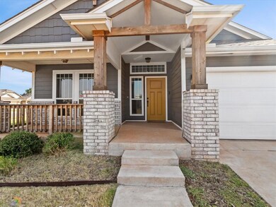 Entrance to property with a garage and covered por