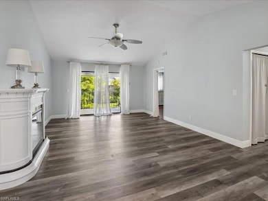 Unfurnished living room featuring ceiling fan, dar