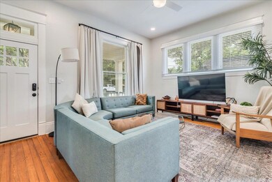 Living room featuring ceiling fan, hardwood / woo