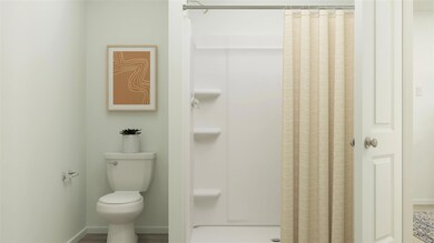 Bathroom with a shower with curtain and toilet