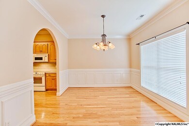 Large windows, volume ceilings and crown moulding add a lot of class to the dining room.
