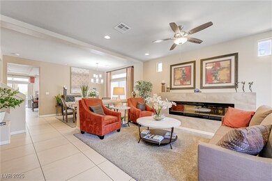 Living area featuring a fireplace, light tile patt