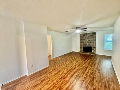 Unfurnished living room with ceiling fan, wood fi