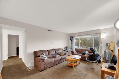 Living room with carpet floors and baseboards