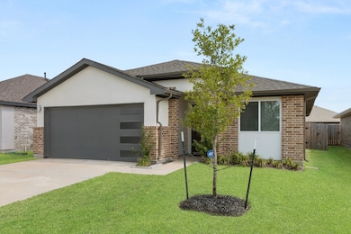 This charming home features stunning front yard landscaping that adds curb appeal and a warm, inviting entrance.