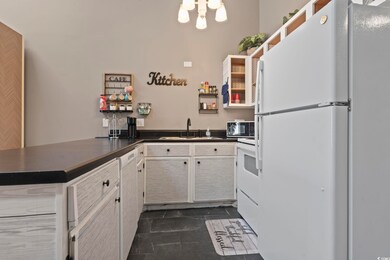 Kitchen with white cabinets, white appliances, kit