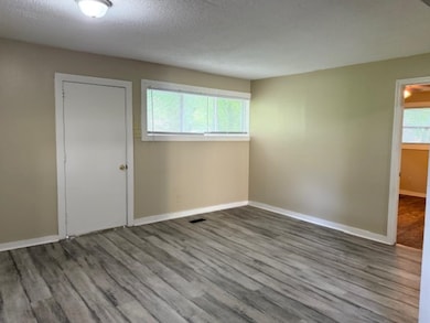 Breakfast Area featuring LVP wood finished floors, baseboards, and a textured ceiling