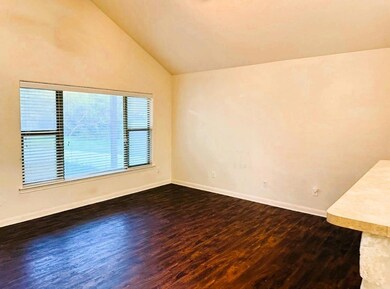 Spare room featuring baseboards, lofted ceiling, 