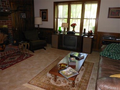 Cozy family room with raised brick hearth fireplac