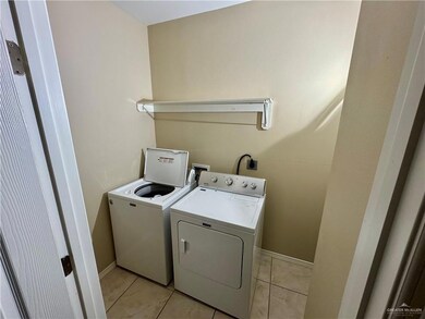 Laundry area with laundry area, baseboards, separate washer and dryer, and light tile patterned flooring