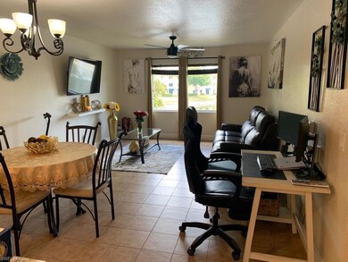 Office with a textured wall, a textured ceiling, light tile patterned flooring, and a chandelier