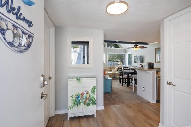 Entryway featuring ceiling fan, a textured ceiling