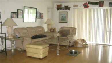 SPACIOUS LIVING ROOM OVERLOOKING THE POOL AND POND