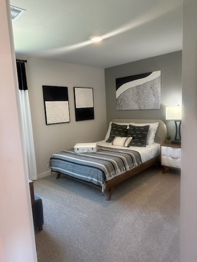 Carpeted bedroom with baseboards