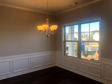 Empty room with dark wood finished floors, a notab
