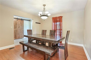 FORMAL DINING FEATURES WOOD FLOORS, NICE CHANDELIE