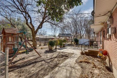 The backyard includes an open patio, covered deck,