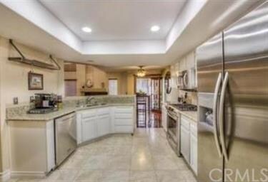 Kitchen with travertine floor, granite counters, s