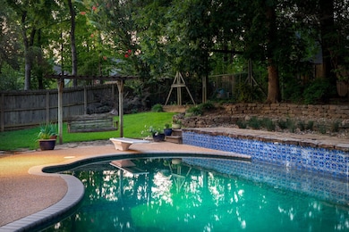 View of pool featuring a diving board and a fenced backyard