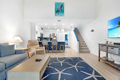 Living room with stairs, light wood-style floors, recessed lighting, and a high ceiling