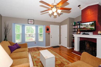 open living room with wood burning f/p